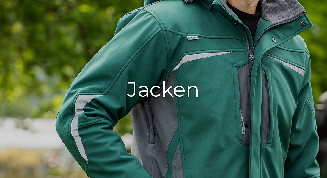 Person trägt eine grüne Softshell-Arbeitsjacke mit grauen Einsätzen und reflektierenden Streifen. In der Bildmitte steht der Schriftzug „Jacken“.